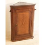 A George III period oak and mahogany crossbanded hanging Corner Cupboard,