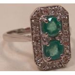 An Art Deco style 18 carat gold Ring set with emeralds and diamonds