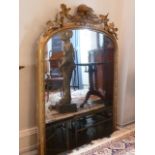 A large 19th Century gilt framed oval topped overmantel Looking Glass,