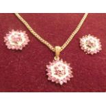 A 9 carat gold ruby and diamond cluster Necklace and Earrings