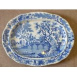 An early/mid 19th Century blue and white transfer decorated oval Meat Platter depicting a boating