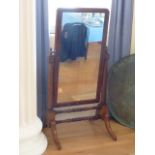 A large late Regency period mahogany framed Cheval Mirror on four downswept legs,