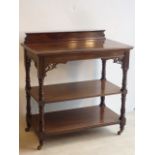 A late 19th/early 20th Century three tier mahogany Buffet on baluster turned supports terminating