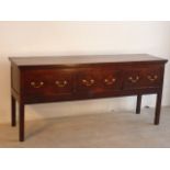 A George III period oak Dresser, three frieze drawers with brass swan neck handles,