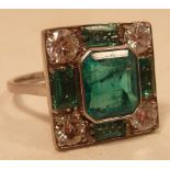A fine 18 carat Art Deco style ladies Ring set with a large emerald centre stone bordered by