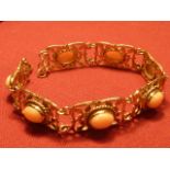 A 9 carat gold Bracelet with seven coral links