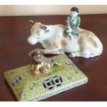 A late 19th Century Chinese porcelain model of a young boy seated upon the back of a recumbent ox