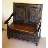 An antique oak Box Settle (made up from earlier parts),