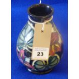 A modern Moorcroft baluster shaped pottery Vase, tube lined with various flowers and leaves etc.