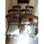 A set of six Regency period mahogany Dining Chairs, each with concave tablet shaped top rail,