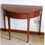 A George III period bow fronted mahogany and boxwood strung fold over top Tea Table raised on