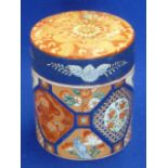 A late 19th Century Japanese cylindrical porcelain Jar and Cover hand decorated in the Imari