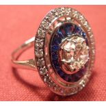 An 18 carat white gold Ring 1 carat diamond with sapphire and diamond surround