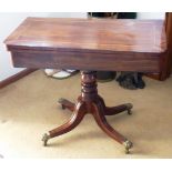 An early 19th Century mahogany and brass inlaid fold over top Card Table with turned stem,