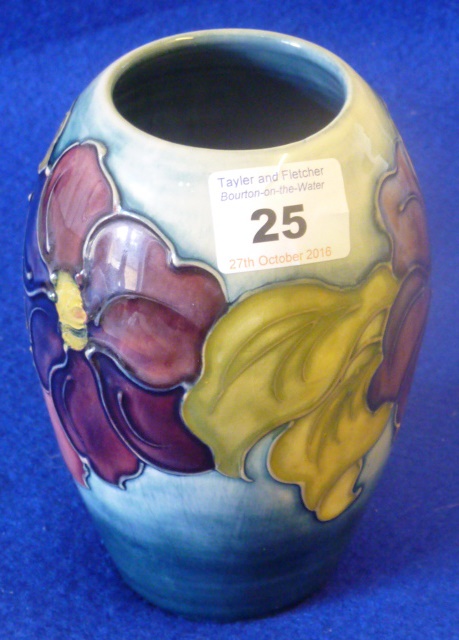 A Moorcroft pottery baluster shaped tube lined Vase in the Clematis pattern, painted green,