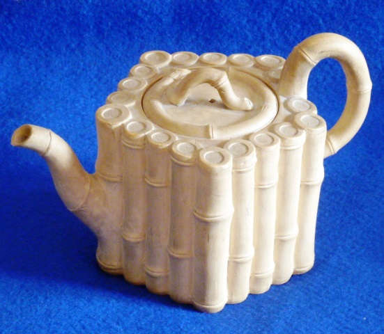 A late 18th Century basalt Tea Pot by Wedgwood & Bentley (impressed mark to underside), the lid,