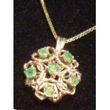 A 14 carat white gold Pendant set with emeralds on a 14 carat Chain