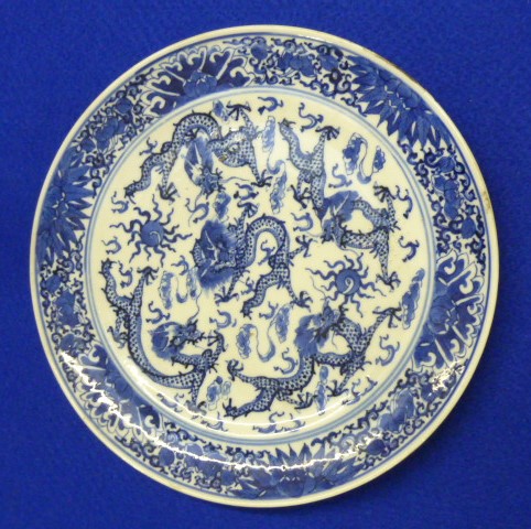 A Chinese porcelain dragon Plate decorated with a central four clawed dragon and four further