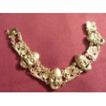 A very heavy 18 carat gold Bracelet set with mask heads and diamonds CONDITION REPORT: