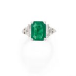 An emerald, diamond and gold ring.