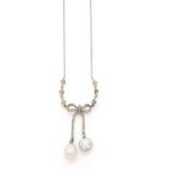 A diamond, natural pearl, platinum pendant.