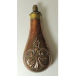 A 19th Century copper and brass powder horn with graduated nozzle and foliate decoration, 19.5cms