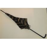 A Victorian parasol with carved dark wood handle and with striped and spotted silk canopy, 91cms