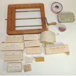 A Victorian wood and brass bandage winder; a tourniquet; 11 assorted packaged dressings including