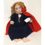 A German bisque socket head doll with blond wig, sleeping blue glass eyes, open mouth with teeth and