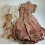 An early 20th Century Pedigree composition baby doll with painted features (needs total re-