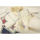 A quantity of assorted table linen - embroidered cloths, printed cloths, small mats, crochet edged