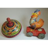 A Chad Valley tinplate spinning top with colour printed nursery rhyme figure decoration and together