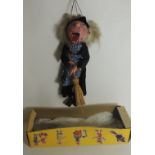 A Pelham Puppet Witch with broomstick, in base of box