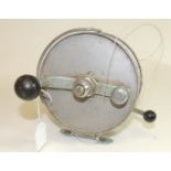 A large sea fishing reel by Allcock, 6" diam, white metal with black handle