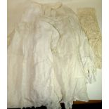 A long flounce of white cotton bobbin lace; two Edwardian white cotton babies gowns with cutwork and