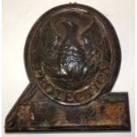 A 19th Century embossed tin fire mark of a phoenix rising from flames "Protection" mounted on wood