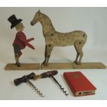 An Edwardian wooden, jointed toy horse and "ringmaster" on wood base together with two corkscrews