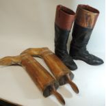 A pair of black leather and brown leather topped gentleman's riding boots together with a pair of