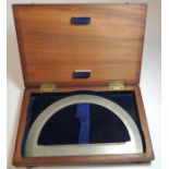 A large late 19th Century white metal protractor in original mahogany box, by Elliott Brothers,