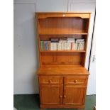 A pine two shelf dresser, the base fitted two cupboard doors enclosing a long shelf and with two