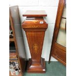 An Edwardian mahogany inlaid pedestal with tapering body inlaid with coloured boxwood urn and tied