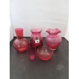 A group of cranberry glass vases