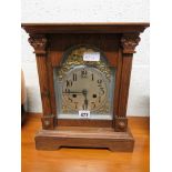 An Edwardian mantel clock in oak architectural case