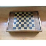 A large wooden games box with chequerboard lid, backgammon interior and containing draughts,