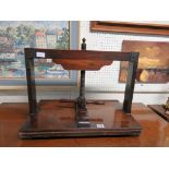 A 19th Century fruitwood and mahogany book press with turned handles and central wood screw