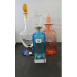 A French La Rochere decanter with yellow stopper and blue foot; a similar orange bubble glass