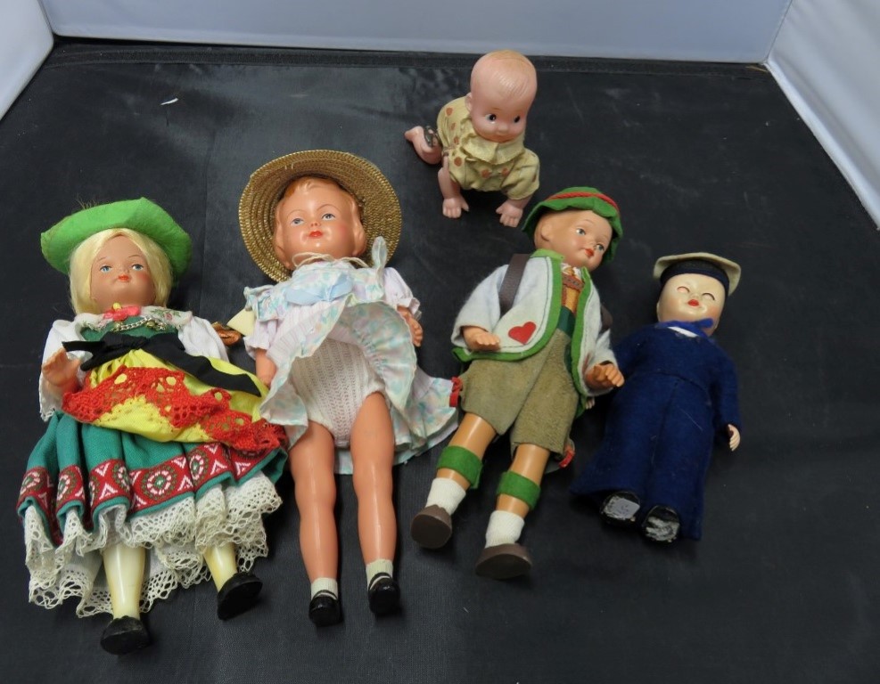 A small clockwork celluloid doll and other dolls