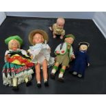 A small clockwork celluloid doll and other dolls