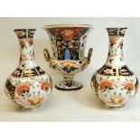 A 19th Century Crown Derby Campana shaped vase in typical Imari palette with serpent handles 20cm