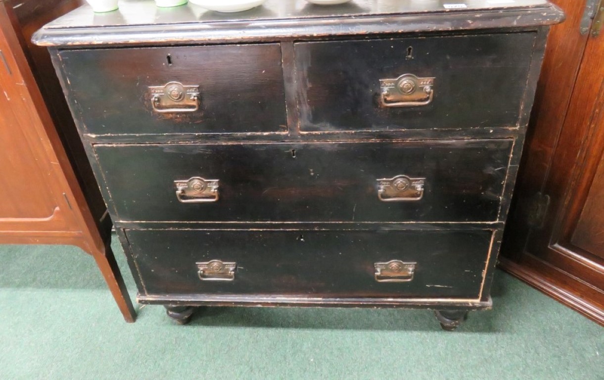 A small Victorian stained pine chest of two short and two long drawers on short baluster feet